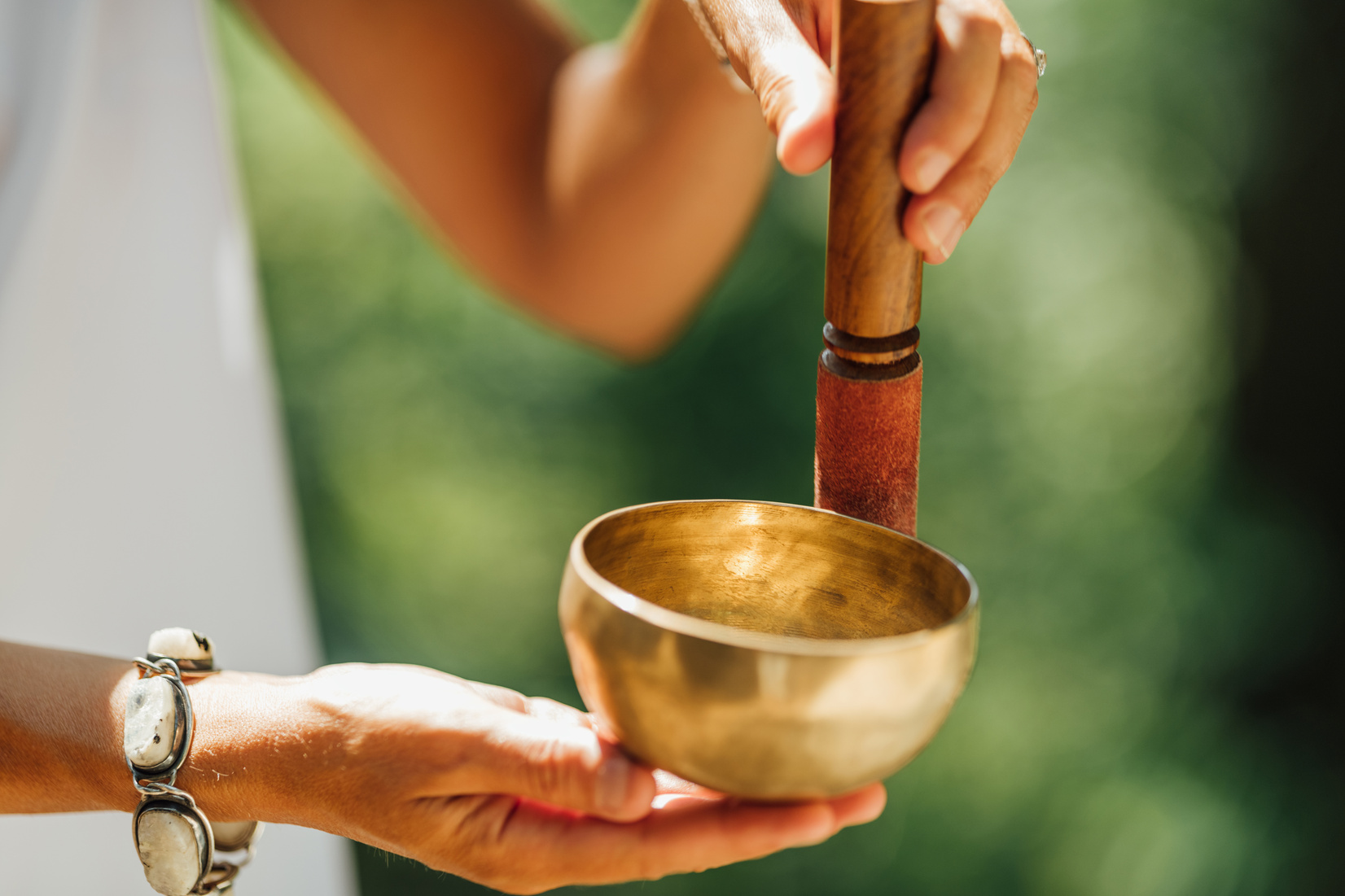 Hands Holding Tibetan Singing Bowl Outdoors